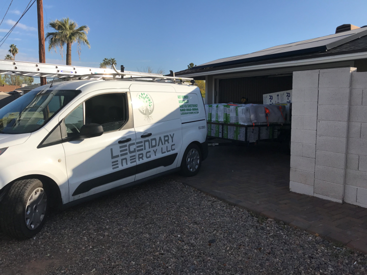 Legendary Energy service van at a Phoenix house with boxed equipment in the garage