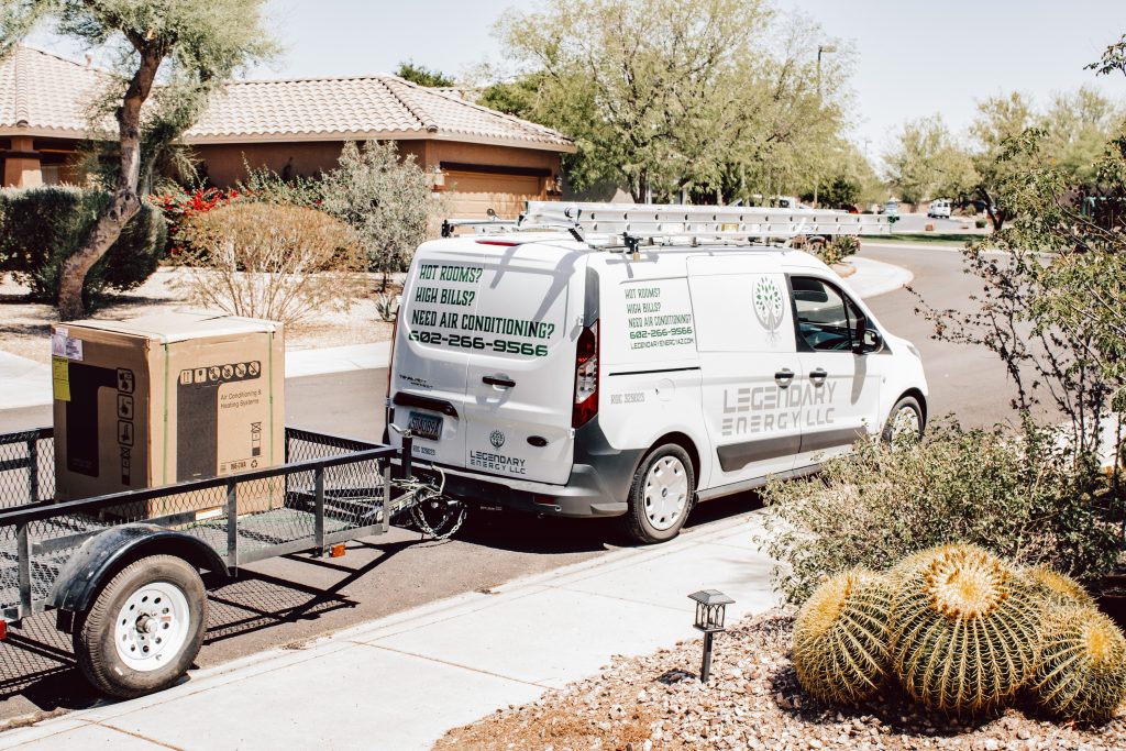 Legendary Energy van and trailer parked outside a Phoenix home for a service call