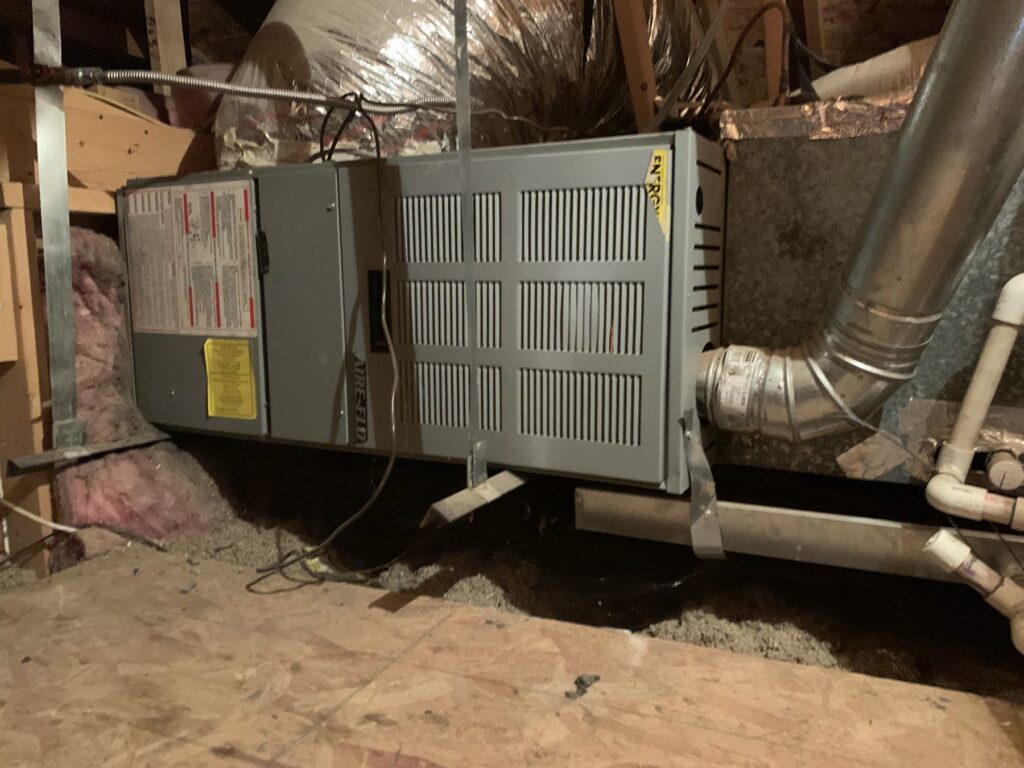 Attic air handler with supply ductwork and condensate piping