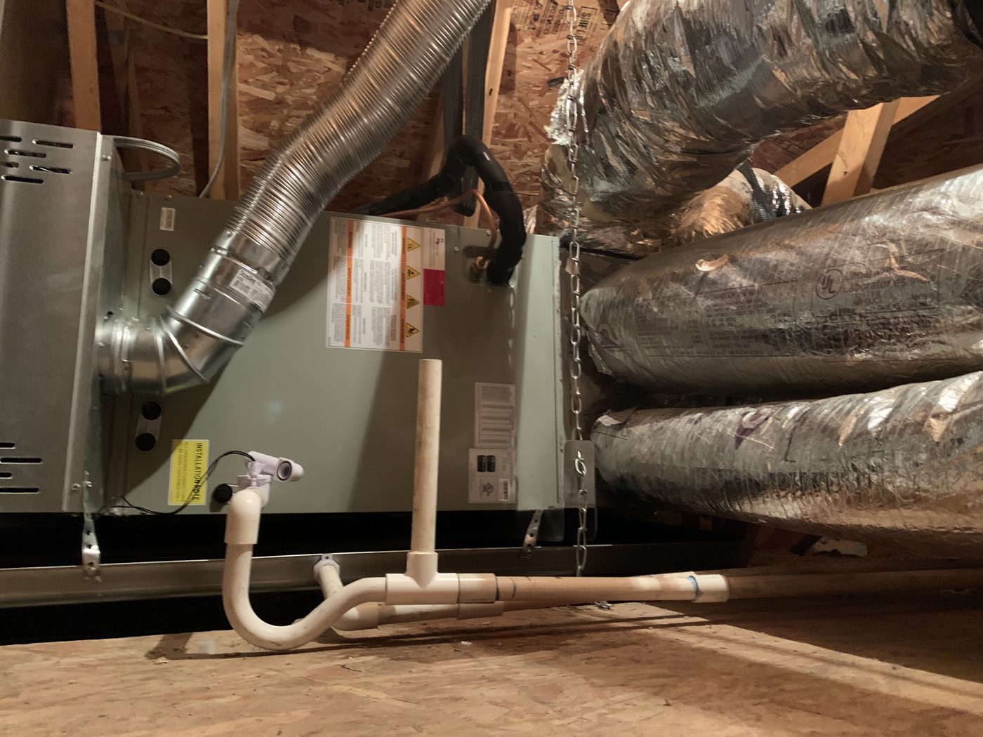 Attic air handler with insulated flexible duct runs connected at the plenum