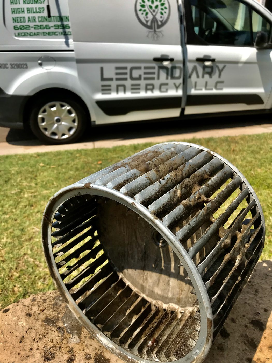 Dirty blower wheel pulled from an HVAC system with dust built up on the blades