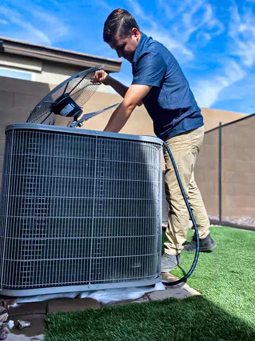 Legendary Energy technician servicing an outdoor AC condenser unit