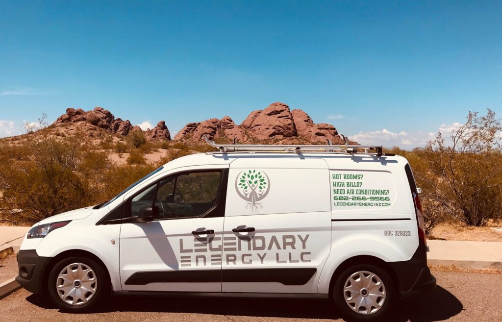 Legendary Energy HVAC service van parked with desert buttes behind it
