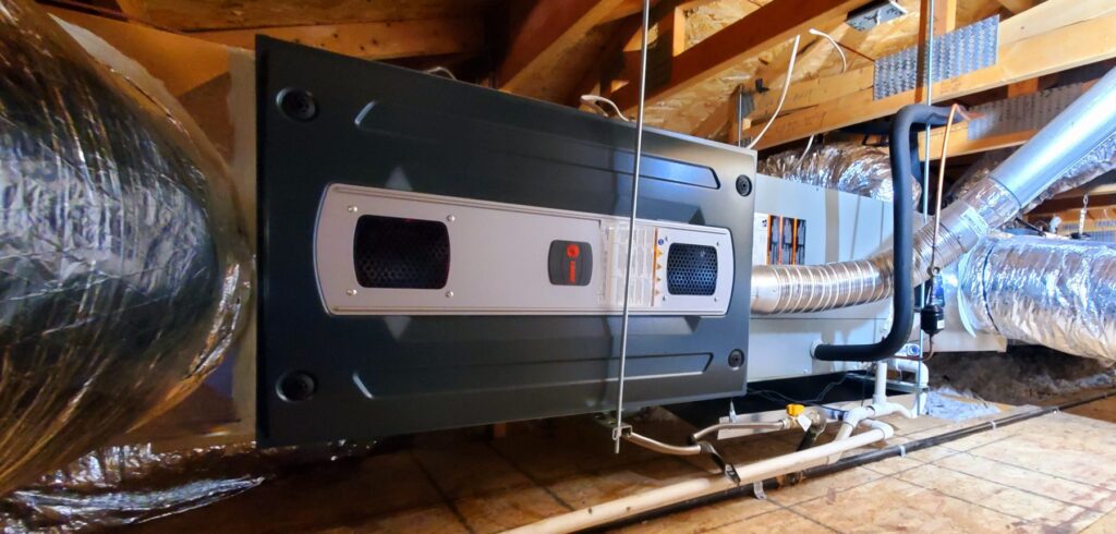 Newly installed air handler with insulated ductwork in an attic
