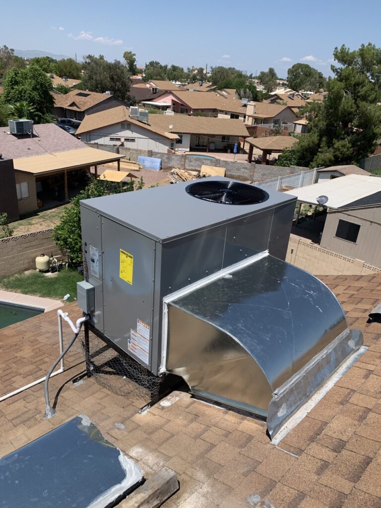 New rooftop package unit installed on a shingle roof